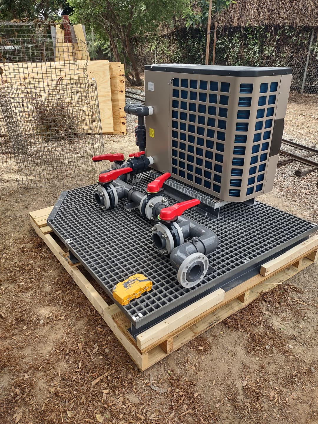 Commercial water cooling system with valves on a raised platform in an outdoor setting.